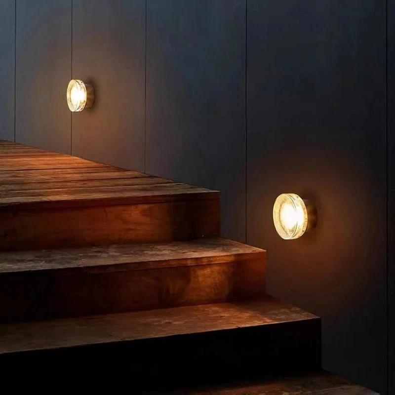 Nordic LED Wall Sconce, two units visible on dark wall beside wooden steps, warm light.