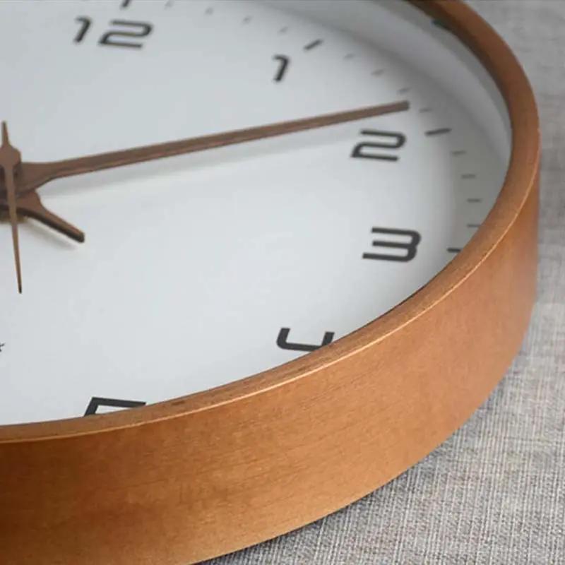 Close-up of a clock with a brown frame on a textured surface