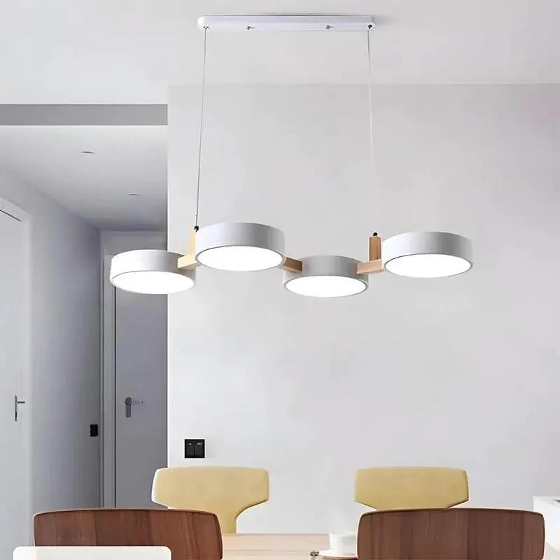 Scandinavian four-light pendant lamp with white LED diffusers above contemporary dining table (10795371266381)