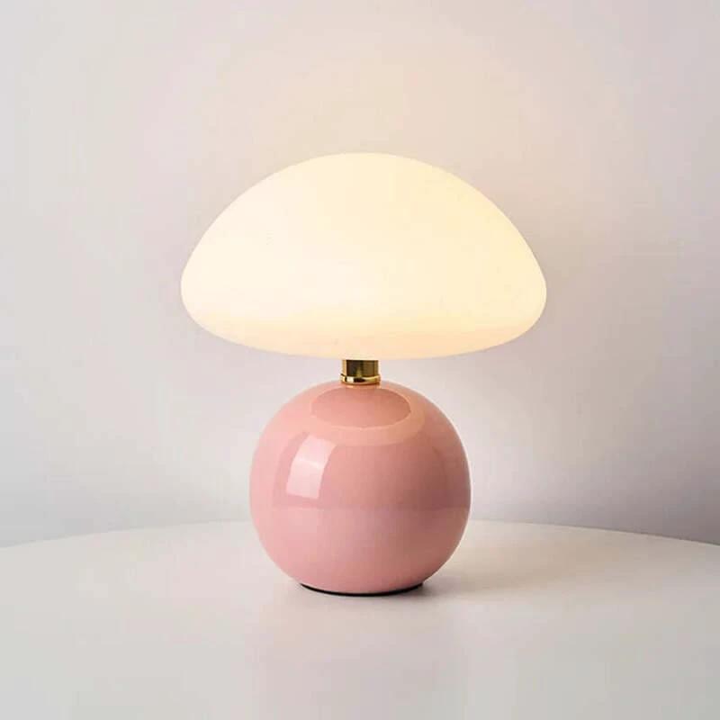 Pink modern ceramic table lamp with a white shade on a light gray background