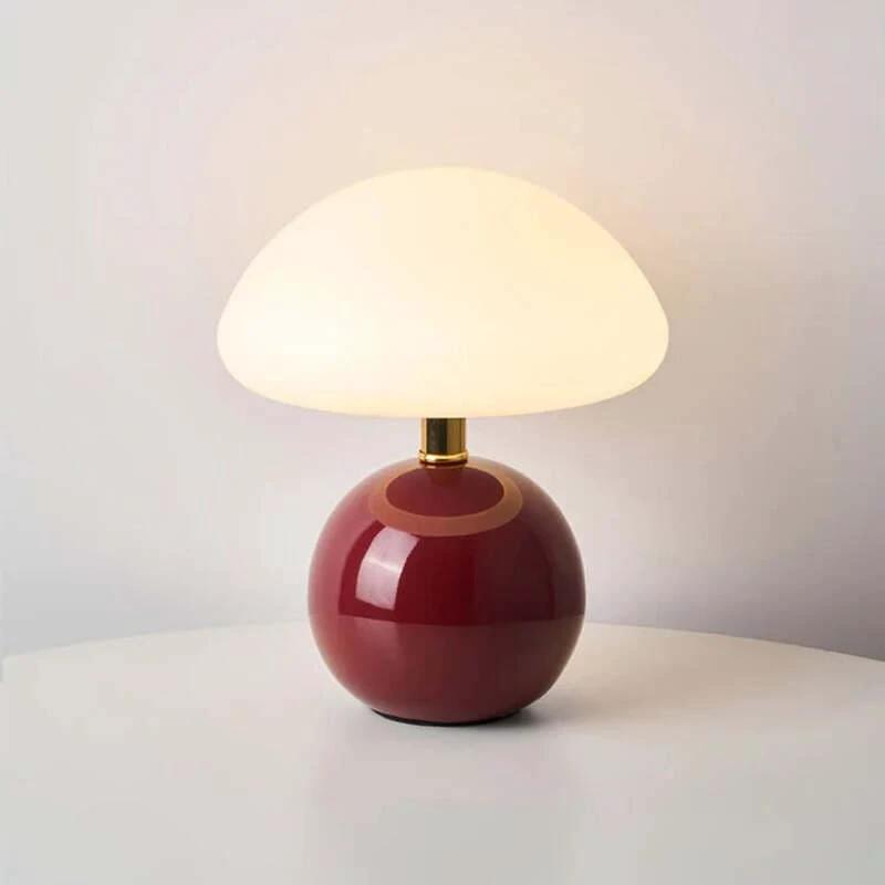 modern ceramic table lamp with a red base and white shade on a light gray background