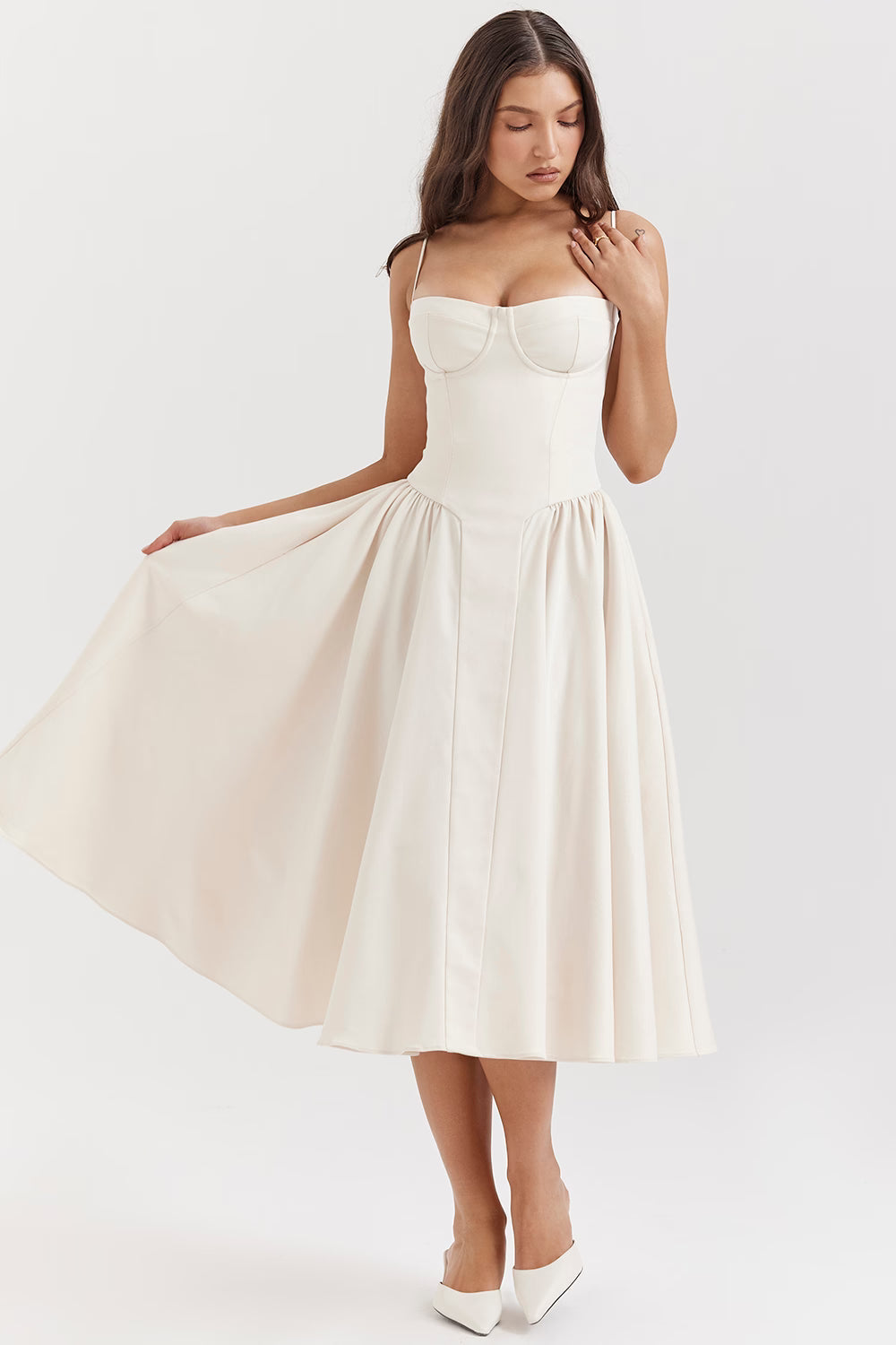 Cream corset midi dress side view with flowing skirt and pockets
