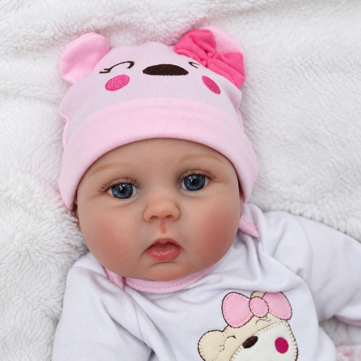 Realistic reborn newborn baby doll, 18 inch, side view in outfit