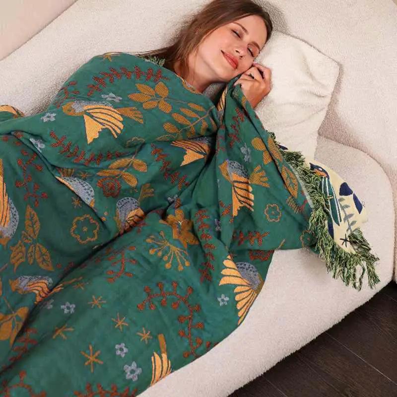 100% Cotton Reversible Throw Blanket – Decorative Bird Pattern for Sofa & Bed, teal with mustard birds, used on a sofa, Nordic Essentials.