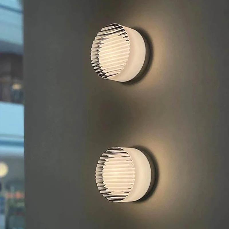 Nordic LED Wall Sconce, two circular ribbed metal wall lights mounted on a dark wall with a warm glow.