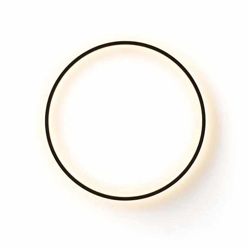 Ring LED Wall Lamp with a black circular frame mounted on a wall, emitting warm light.