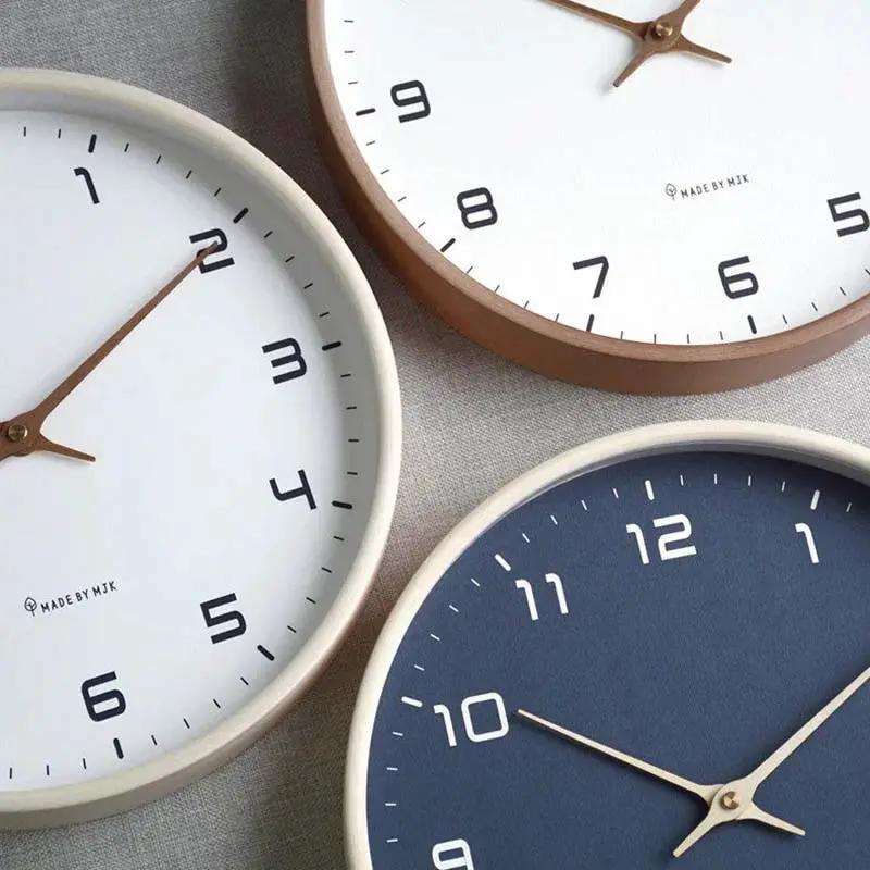 Nordic Wooden Wall Clock - Minimalist Silent Timepiece, three wood-framed clocks in white and navy on fabric, Made by Mik.