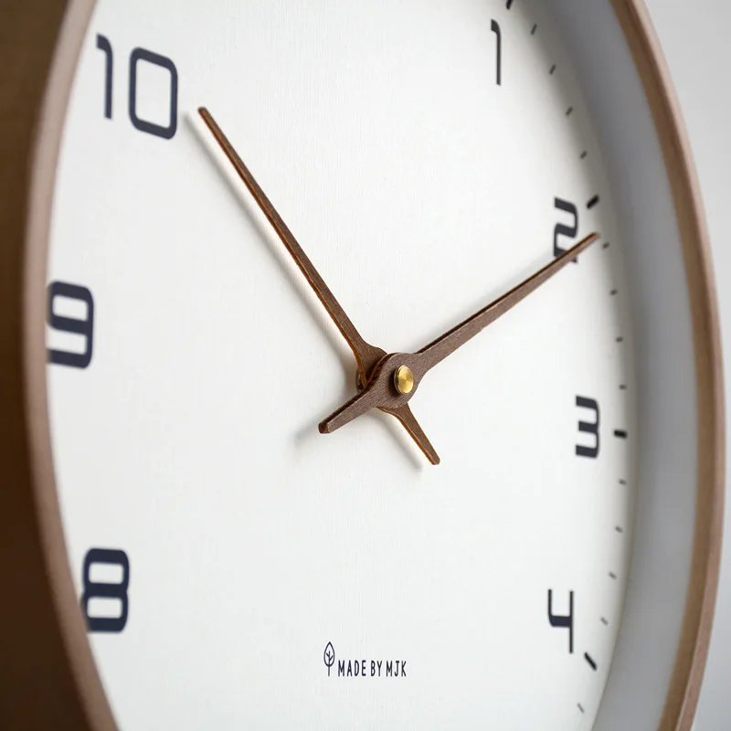 Nordic Wooden Wall Clock with white dial, black numerals and brown hands, Made by MTK, mounted on wall.