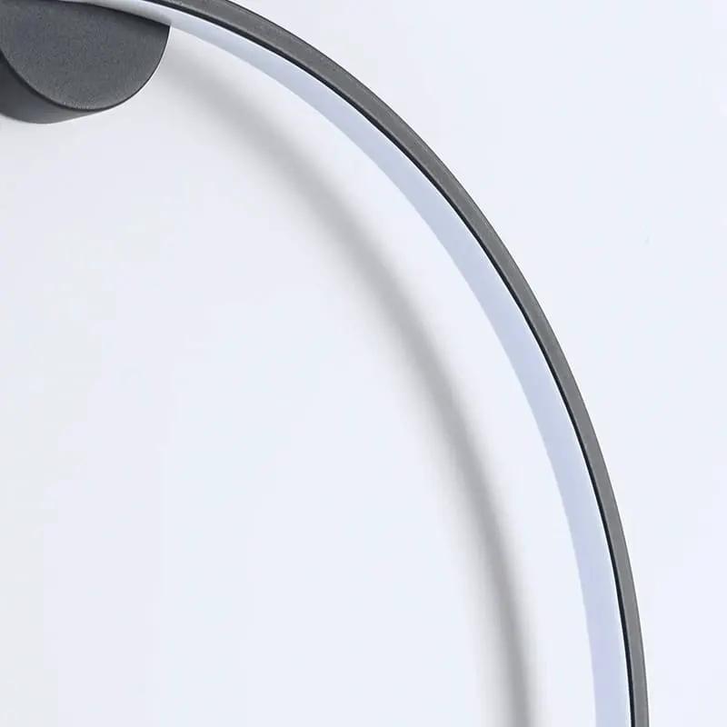Close-up of KRETS black LED ring wall light with acrylic diffuser and minimalist circular metal frame