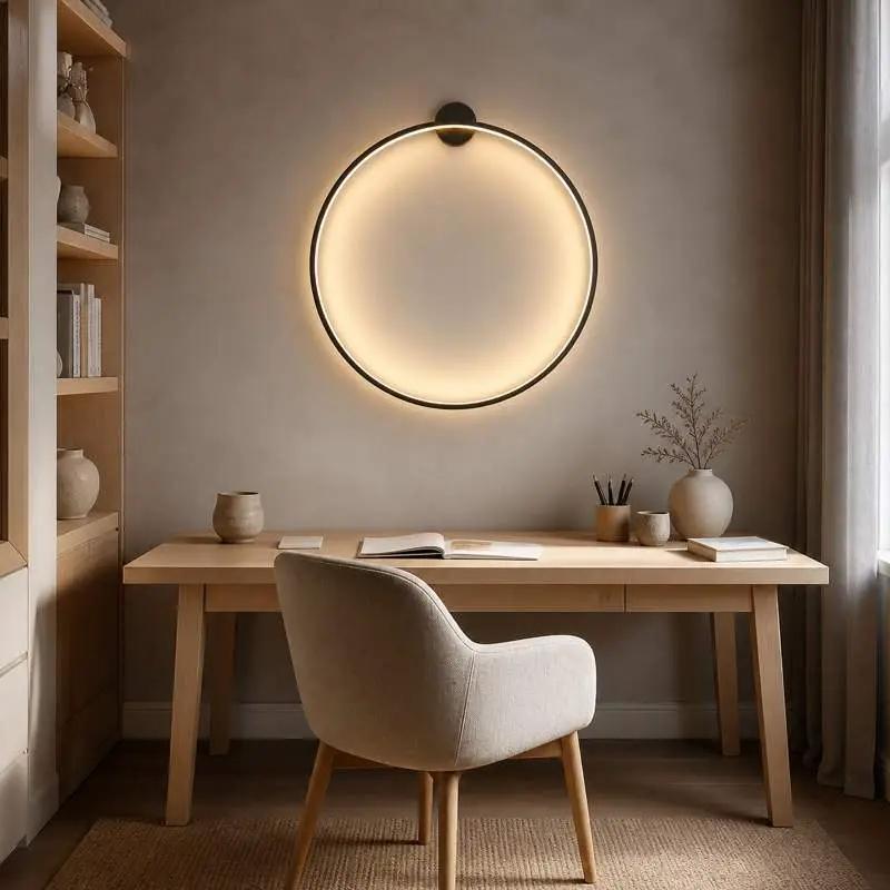 KRETS black LED ring wall lamp above a Scandinavian home office desk with warm ambient illumination