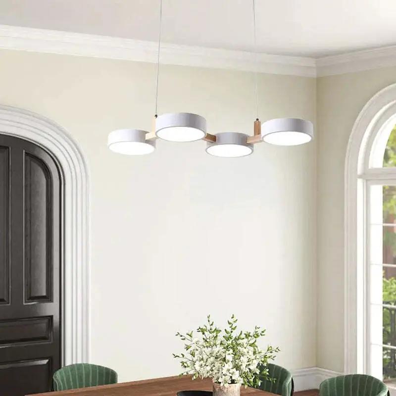 Scandinavian four-light pendant lamp with white LED diffusers above contemporary dining table (10795371266381)