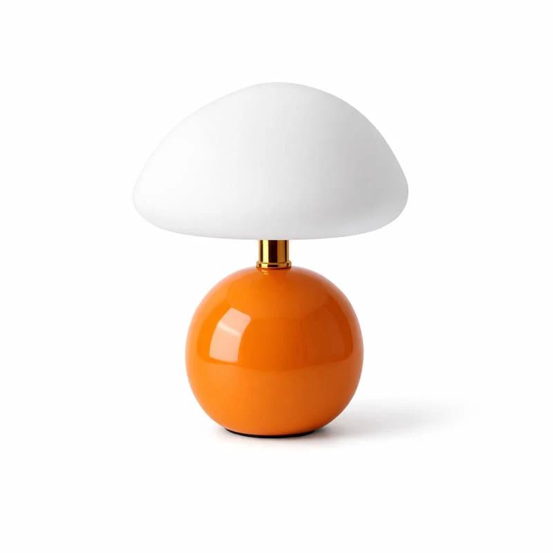 Nordic Ceramic Mushroom Table Lamp with orange ceramic base and white mushroom shade on a white surface.
