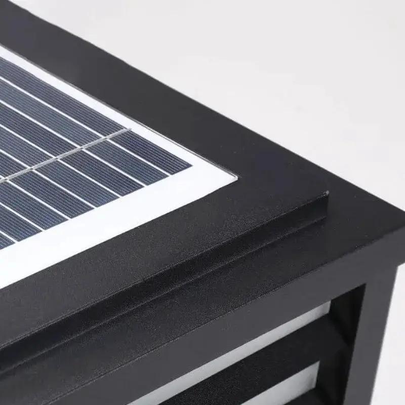 Integrated solar panel detail on Scandinavian waterproof outdoor fence light with black aluminium finish